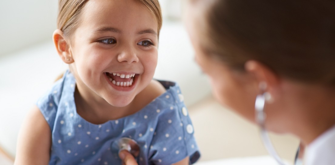 little_girl_with her heart_stethoscope_laughing with doctor