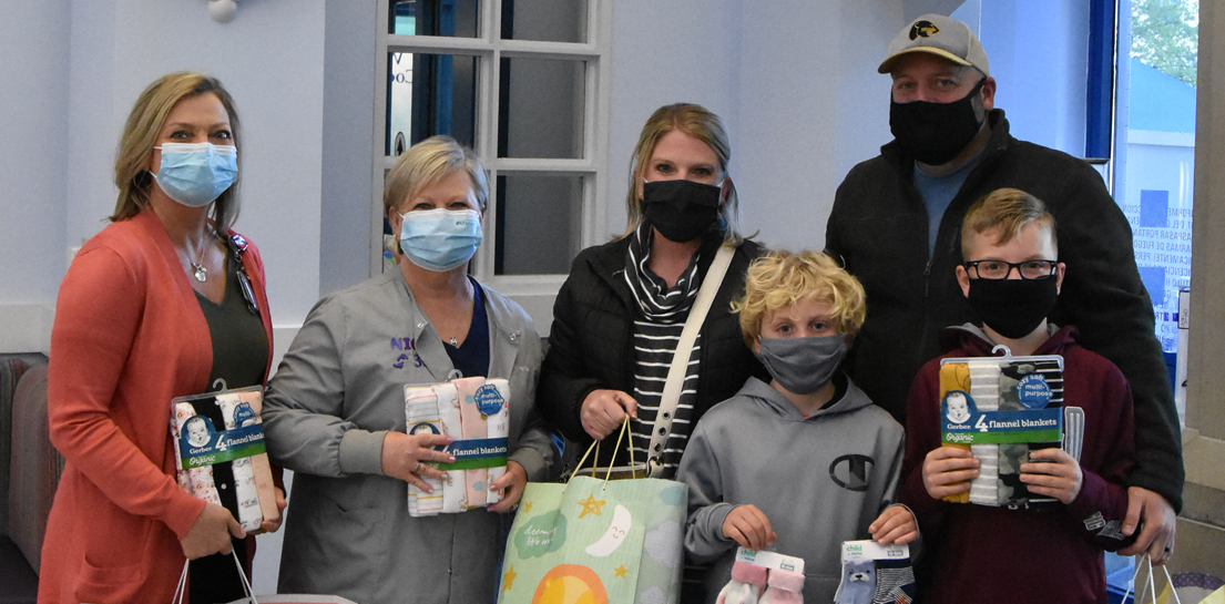 Parents bringing baby gifts