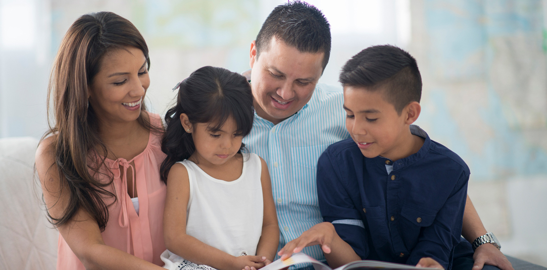 Family reading a booklet