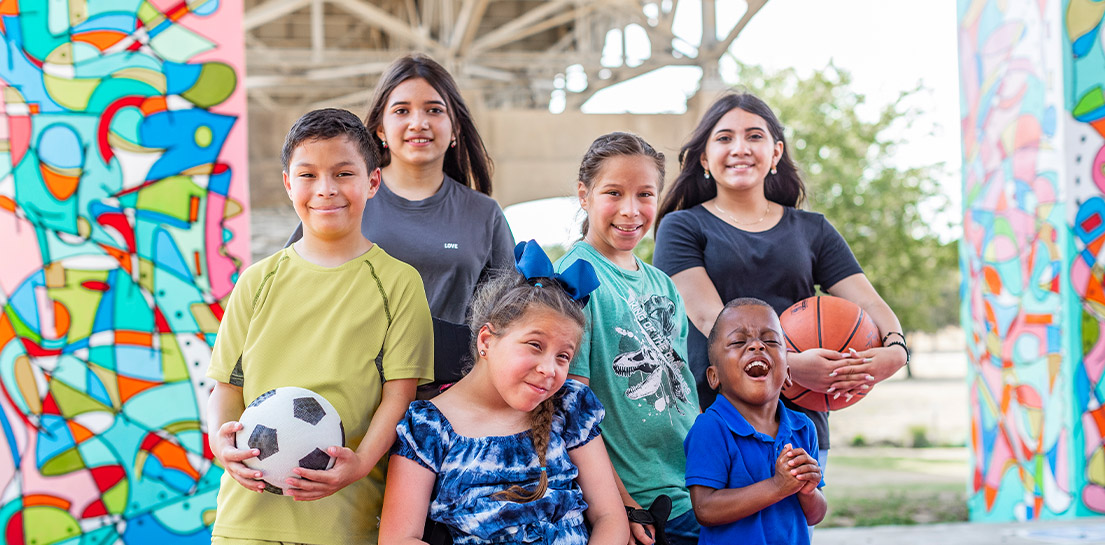 Group of kids ages 5 to teen together in park