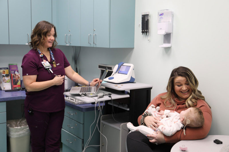 Cook Children's audiology patient, baby Adalyn hearing her mother's voice for the first time as audiology technician looks on