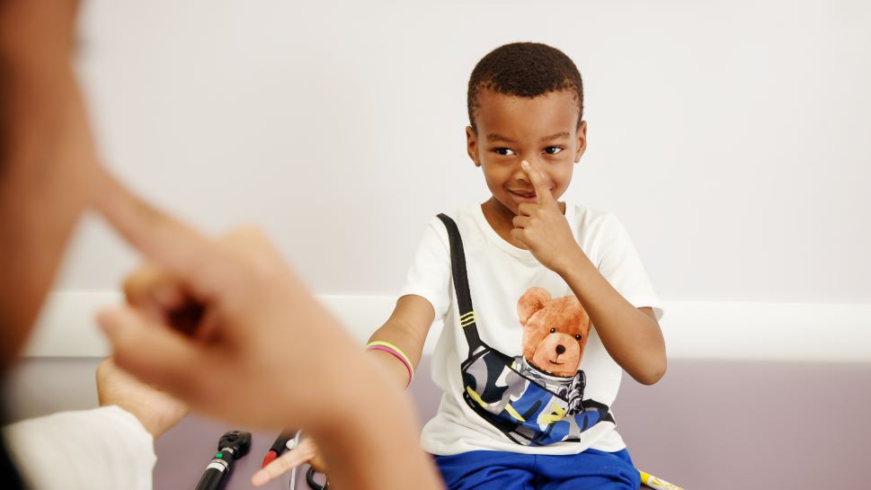 Boy touching his nose