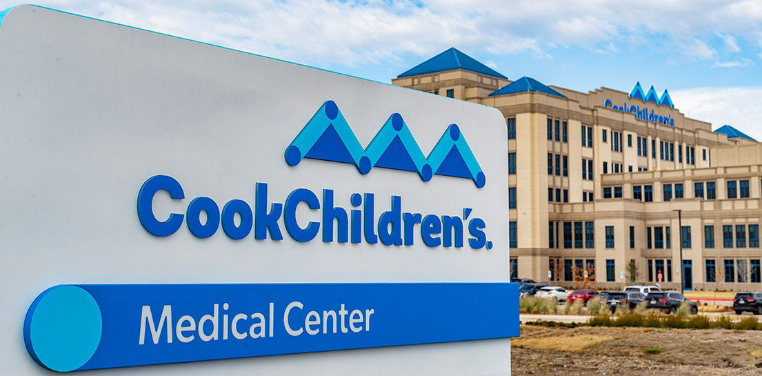 Sign: Cook Children's Medical Center. Behind it, the hospital building with Cook Children's logo