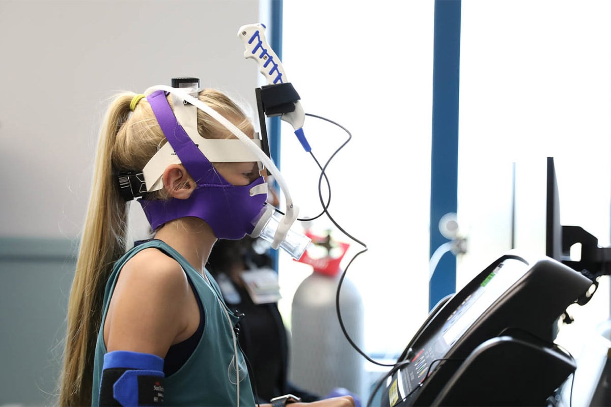 girl on treadmill having her breathing tested while running