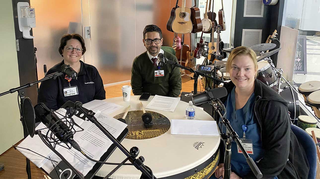 Heidi, Vallance, and a man record a podcast at Cook Children's music studio. Microphones and instruments are visible