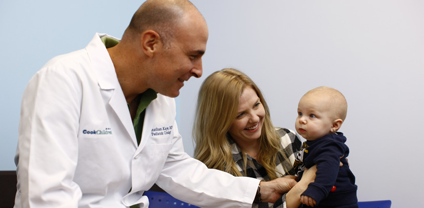 Cook Children's Dr. Jonathan Kaye (Pediatric Urology) smiles at a mother and baby