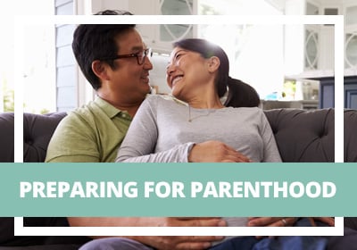 Smiling pregnant couple on a couch. Green banner with text PREPARING FOR PARENTHOOD