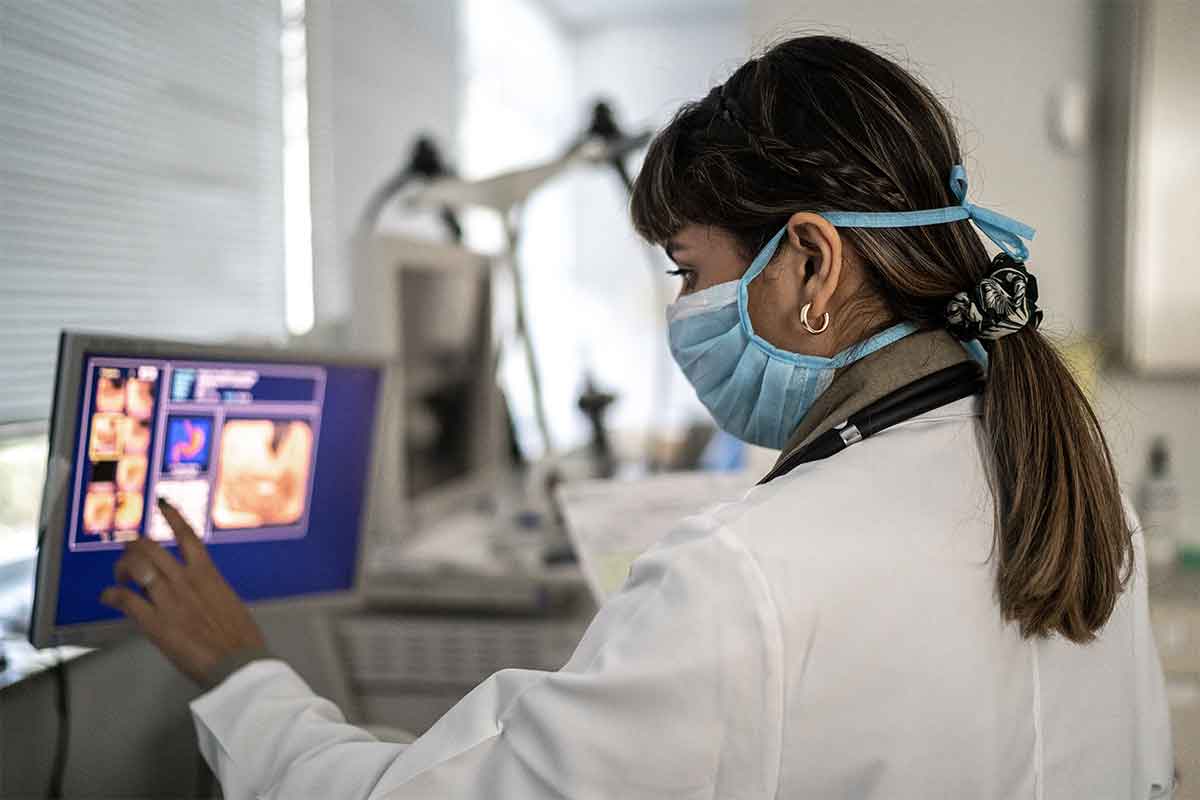 nurse examines monitor
