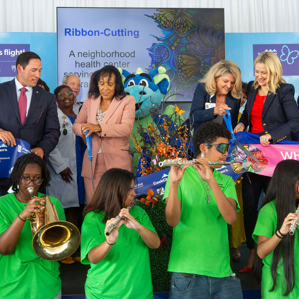 Photo of the Las Vegas Trail grand opening ribbon cutting with the local school band, community members and Cook Children’s community health leaders