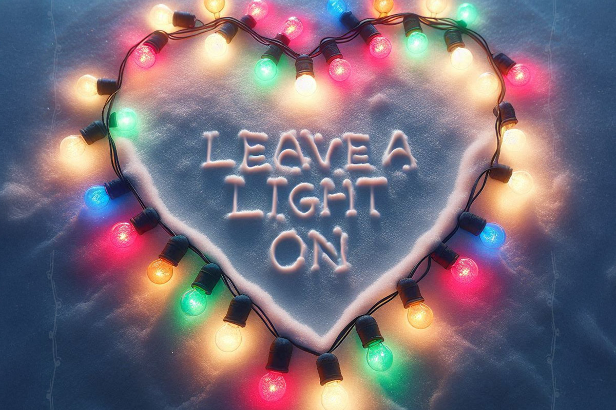 Colorful string lights outline a heart in snow with LEAVE A LIGHT ON written inside