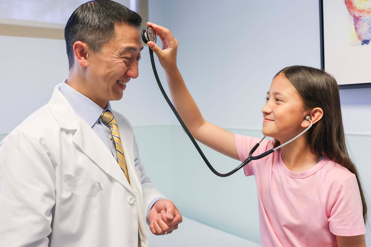 Girl with stethoscope examining Dr. Dao