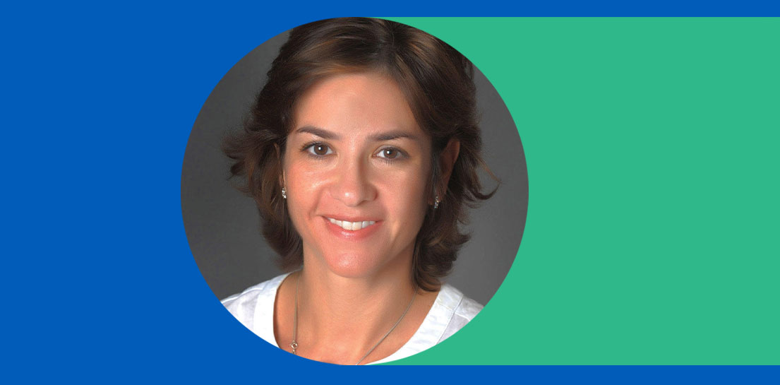 Smiling woman with short brown hair in a white shirt, cropped in a circle on a blue and green background