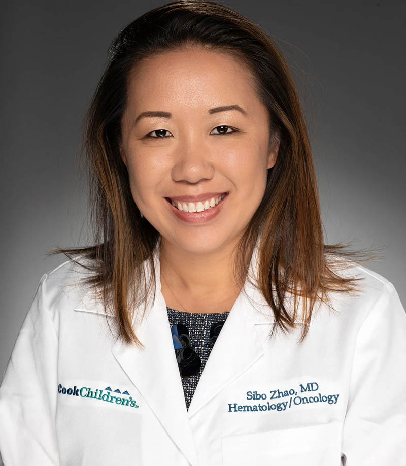 Smiling Asian woman in lab coat. Cook Children's™ logo. Sibo Zhao, MD Hematology/Oncology