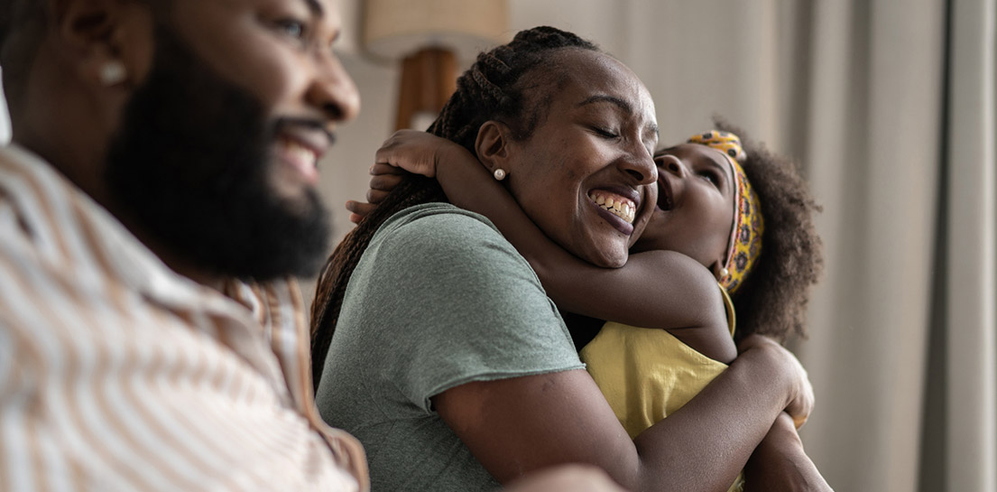 Family smiling with child