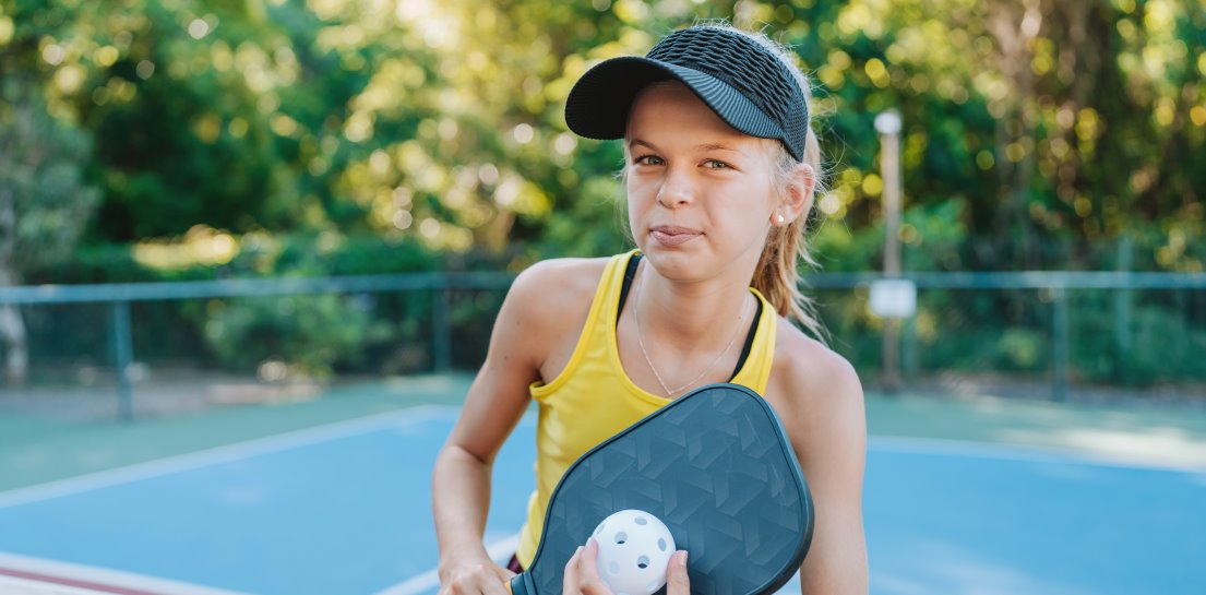 Young girl playing pickleball competitively